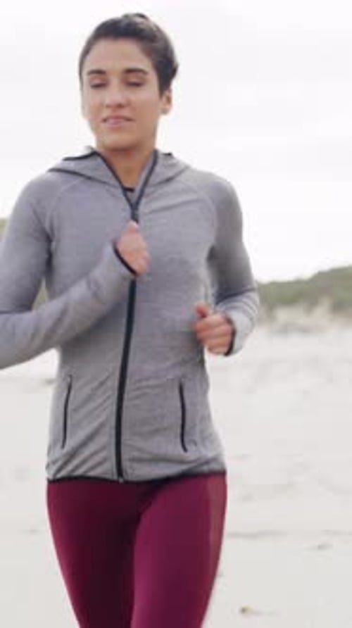 Active, fitness and running with woman on beach in morning for cardio improvement or training