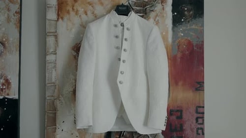 Elegant Groom's Cream Jacket Hanging Indoors