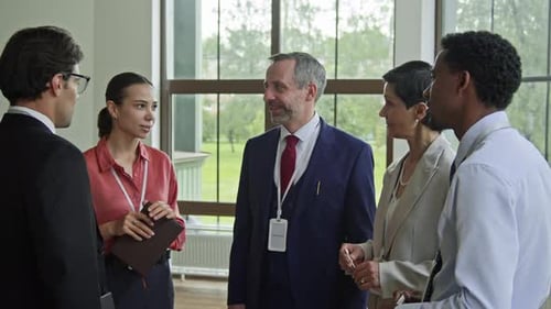 Diverse Business Team Meeting and Handshake Indoors