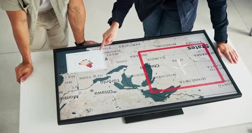 Adults Collaborating With Interactive Map Touchscreen Monitor