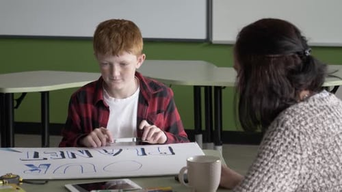 Slow Motion Of Student Making Poster In Class