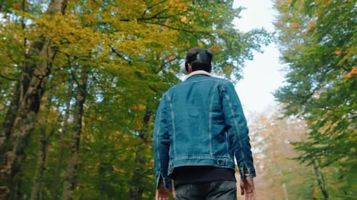 Young Adult Using VR Headset in Autumn Forest