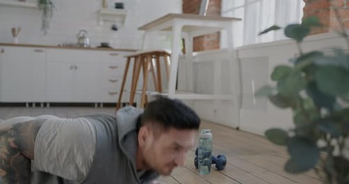 Man Doing Push Ups at Home in Kitchen