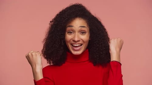 Woman Celebrates Success with Fists in the Air