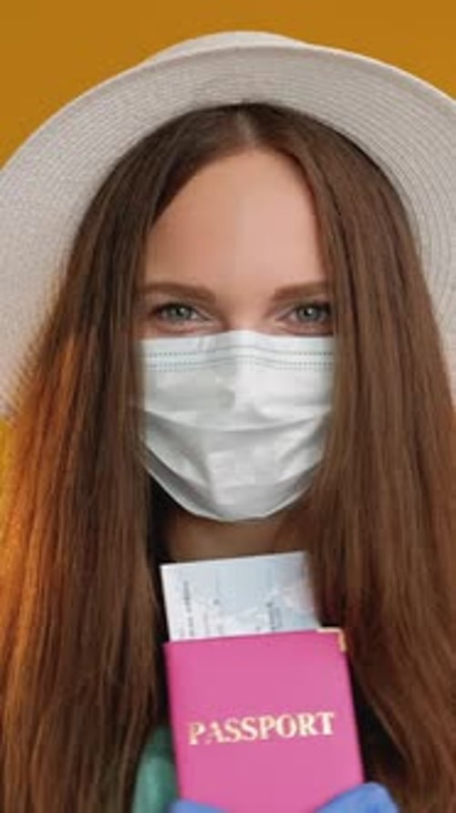 Woman Ready to Travel With Passport and Mask