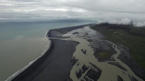Aerial view of black sand beach along the coastline in Iceland.