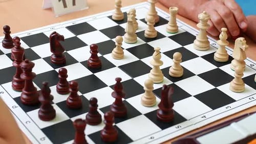 Adults Playing Intense Chess Game Close Up