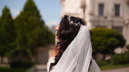Attractive Bride Walks on Path in Sunlight