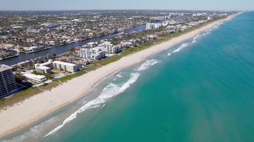 Reveal drone shot of Atlantic Ocean with beaches, hotels and cityscape during the day