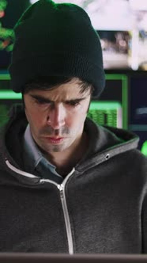 Young Hacker Man Breaking Into Corporate Servers From His Home Office