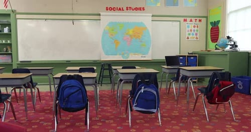 Empty elementary school classroom jib up establishing shot for education content