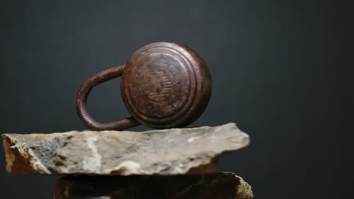 Antique Padlock and Key on Black Stone. Camera Rotates Around Padlock