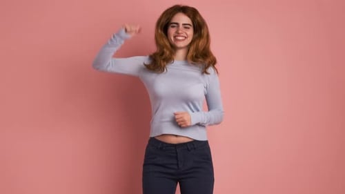 Woman Dancing with Joyful Expression in Studio Setting
