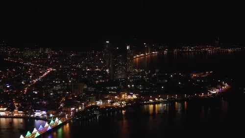Night city lights drone view. Nightlife residential district, aerial footage.