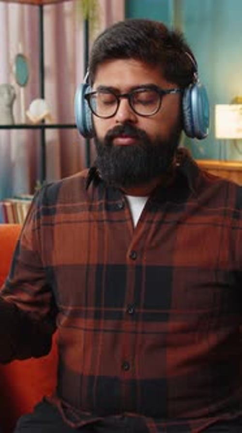 Arabian Man Listening Music Breathes Deeply Meditating with Concentrated Thoughts Peaceful at Home