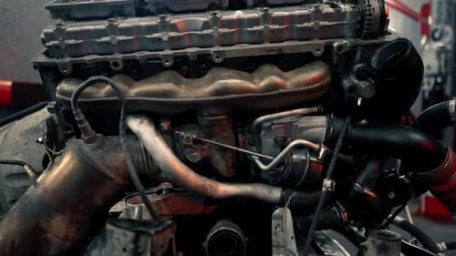 Close Up At a Service Station Closeup of the Motor Part of Car Repairing the Engine Replacing Spare