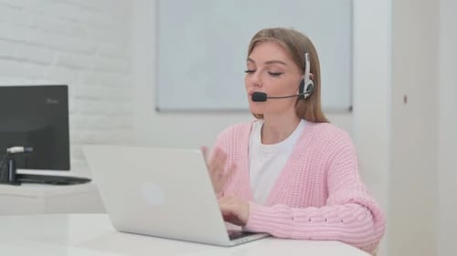 Woman with Headset in Call Center Doing Video Chat at Work