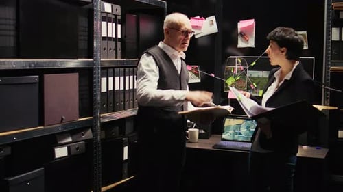Detective Team Analyzes Evidence in Dark Office
