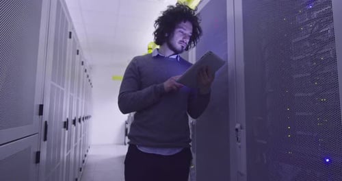Man with Tablet in Futuristic Server Room