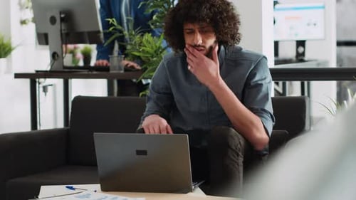 Coworkers Analyze Data Reports in Office