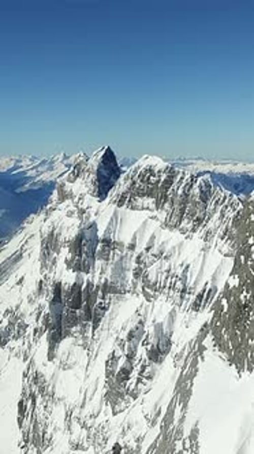 Majestic and Stunningly Beautiful Snowcapped Mountain Peaks Rise Under a Clear Blue Sky