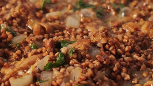 Buckwheat Porridge with Chanterelles Mushrooms Cooking in Pan on Restaurant