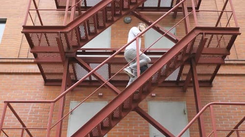 Businessman Climbing Up the Stairs of a Business Centre Confident Man in Formal Wear with Bag