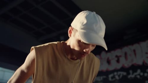 Skater Performing Stunt Trick On Skateboard At Urban City Skatepark. Close Up Focused Stylish Man...