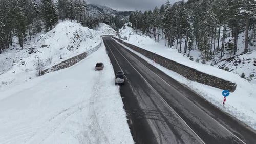 Aerial Top View From Drone of Car Driving on Snowy Ice Road Exploring Local Landscapes in Winter