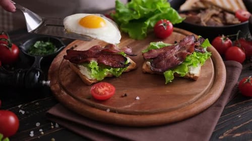 Adding Fried Egg to Bacon Lettuce Sandwich