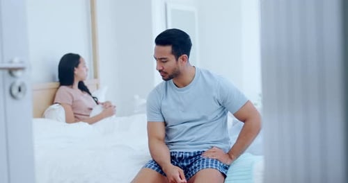 Sad Man Sitting on Bed