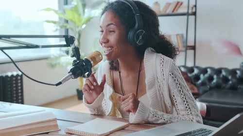 Woman Recording Podcast in Brightly Lit Home Studio