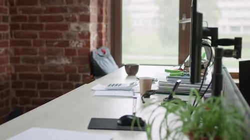 Empty Office Desk with Computers and Business Documents