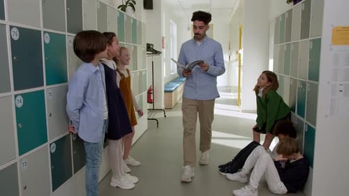 Elementary School Class Children Communicate with the Teacher Answering Question