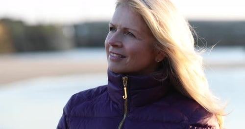 Mature female outdoors looking to camera
