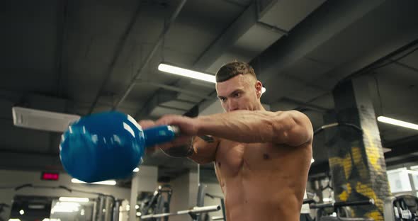 Caucasian Young Man Excising with Kettlebell in Front at Gym Unaltered ...