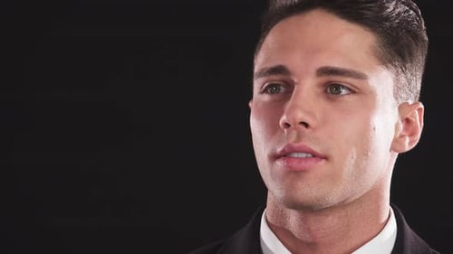 Handsome Man Transitions From Pensive to a Warm Smile