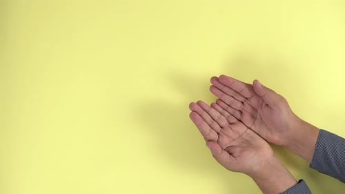 Hands Holding Animated Earth Outline on Yellow