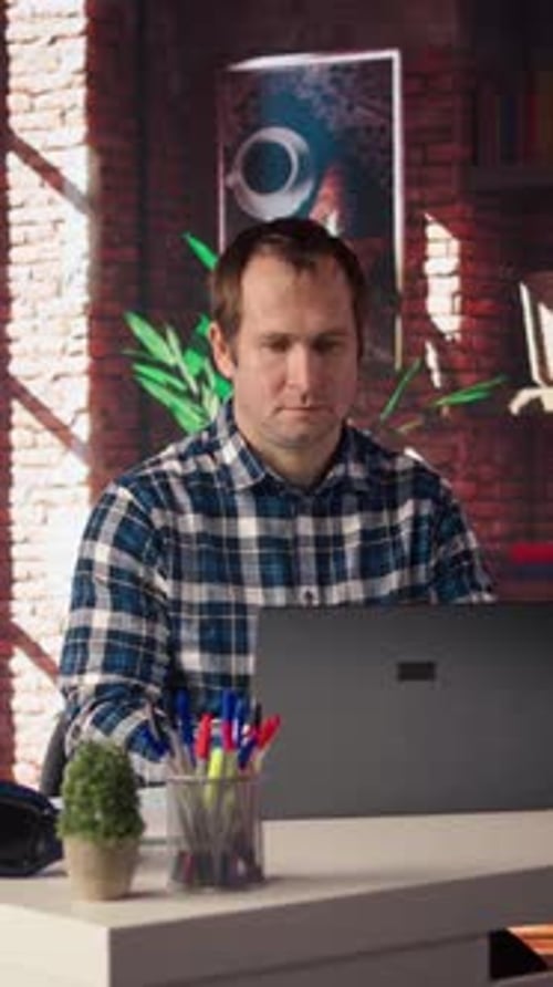 Freelancer in Home Office Sitting at Desk and Typing on Laptop Keyboard