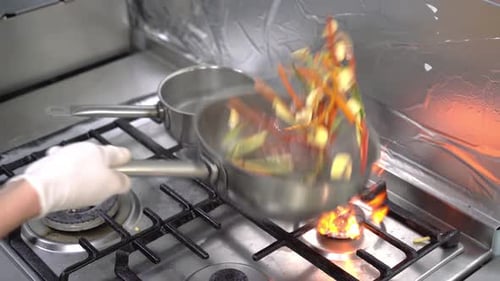The cook bakes vegetables in a pan