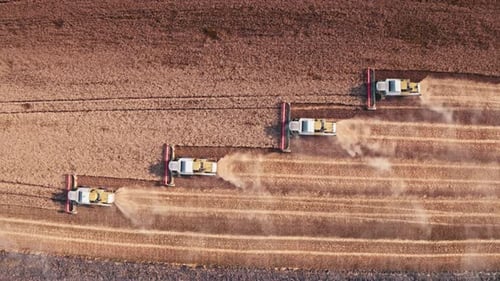 Farm Machinery Working In A Field Aerial