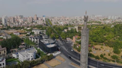 High-angle, wide shot vehicle traffic, modern buildings in Yerevan, Armenia.