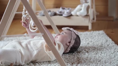 Cute Baby Playing with Wooden Toy in Home