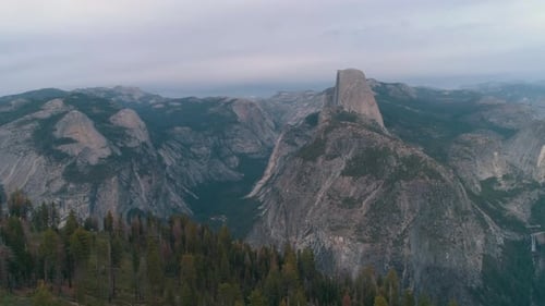 High altitude aerial shot flying over Yosemite National Park and El Capitan formation on background
