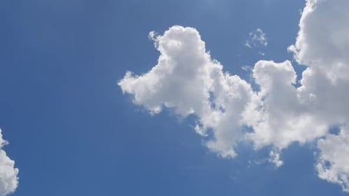 White Clouds Moving Across the Blue Sky