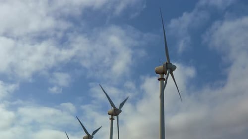 Panoramic View of Wind Turbines Against Horizon
