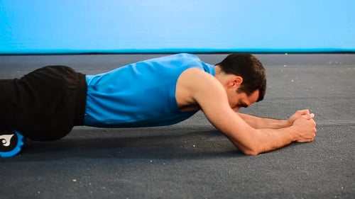 Man Using Foam Roller for Thighs