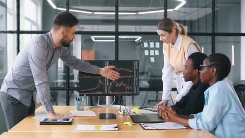 In conference room by the table. Business people are working in the office.
