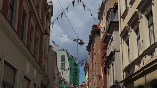 A Charming European Alley Adorned with Colorful Decorative Bunting Showcasing Beautiful Historical