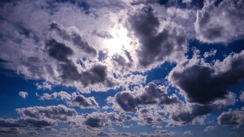 Timelapse of Fluffy Clouds Moving Under the Sun in the Blue Sky
